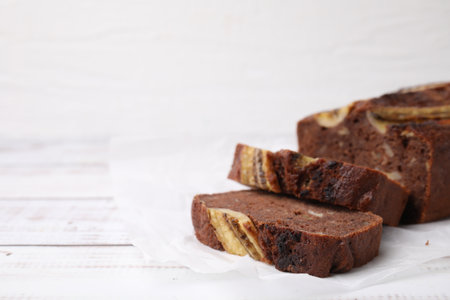 Delicious banana bread on white wooden table. Space for textの写真素材