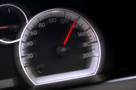 Speedometer on car dashboard, closeup. Motion blur effect