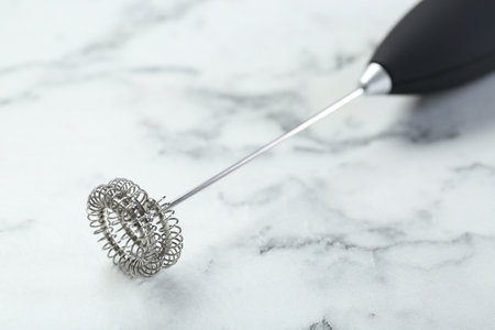 Black milk frother wand on white marble table, closeupの写真素材