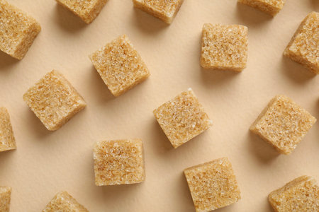 Brown sugar cubes on beige background, top viewの写真素材