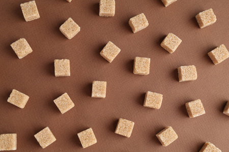 Brown sugar cubes on color background, top viewの写真素材