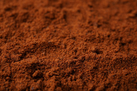 Heap of nutmeg powder as background, closeupの写真素材