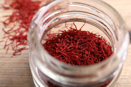 Aromatic saffron in glass jar on table, closeupの写真素材