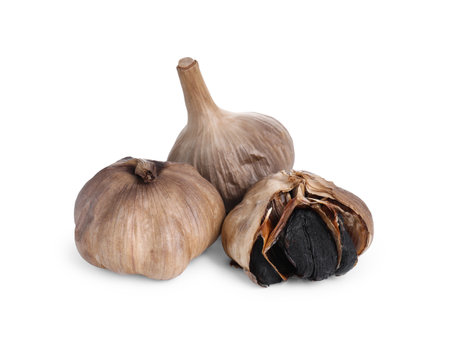 Bulbs of fermented black garlic isolated on whiteの写真素材