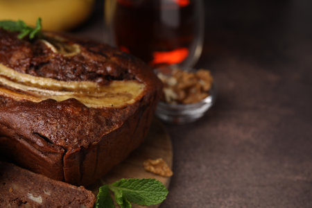 Delicious banana bread on brown table, closeup. Space for textの写真素材
