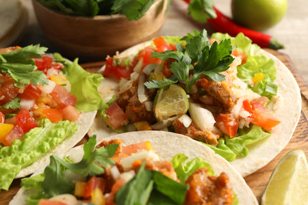 Delicious tacos with vegetables, meat and lime on table, closeupの写真素材