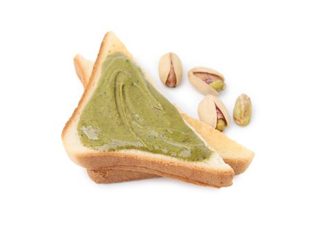 Toasts with tasty pistachio cream and nuts isolated on whiteの写真素材
