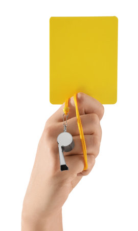 Referee holding yellow card and whistle on white background, closeupの写真素材