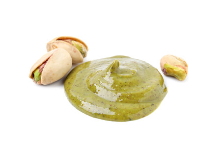 Tasty pistachio cream and nuts isolated on whiteの写真素材