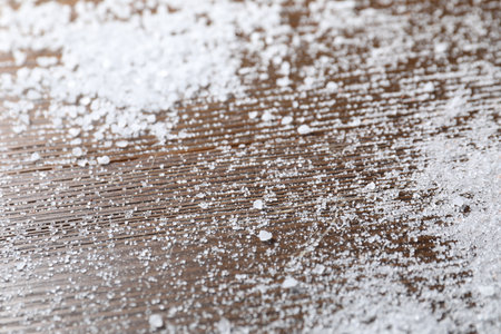 Organic white salt on wooden table, closeupの写真素材