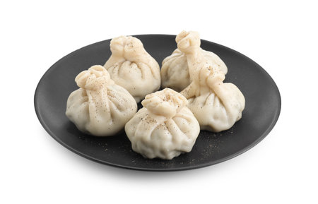 Plate with tasty fresh khinkali (dumplings) and spices isolated on white. Georgian cuisineの写真素材
