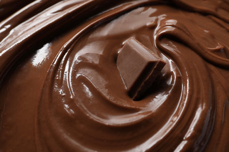 Tasty milk chocolate paste and piece as background, closeupの写真素材