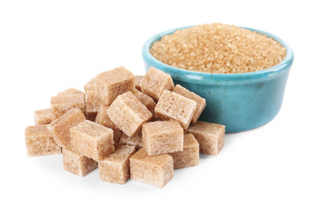 Different types of brown sugar and bowl isolated on whiteの写真素材