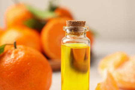 Bottle of tangerine essential oil on blurred background, closeupの写真素材