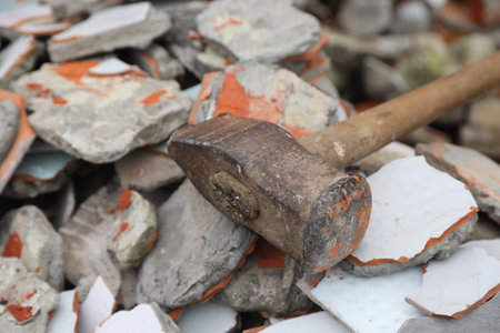 Sledgehammer on pile of broken bricks, closeupの写真素材
