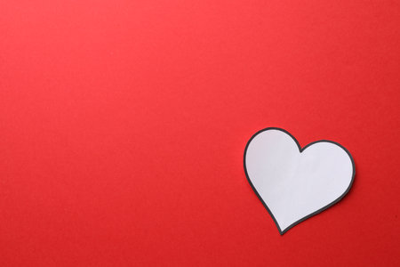 White paper heart on red background, top view. Space for textの写真素材