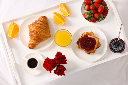 Tray with delicious breakfast on bed, top viewの写真素材