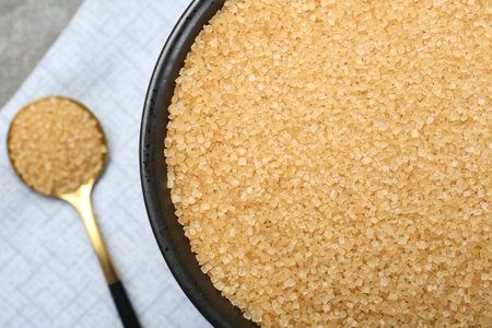 Brown sugar in bowl and spoon on table, top viewの写真素材
