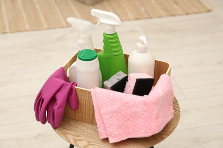 Different cleaning products in wooden box on table indoorsの写真素材