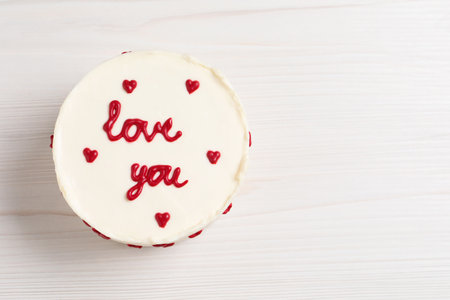 Bento cake with text Love You and space for text on white wooden table, top view. St. Valentine's...