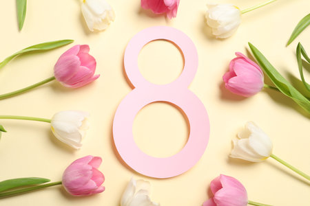 8 March greeting card design with beautiful tulips on light yellow background, flat layの写真素材
