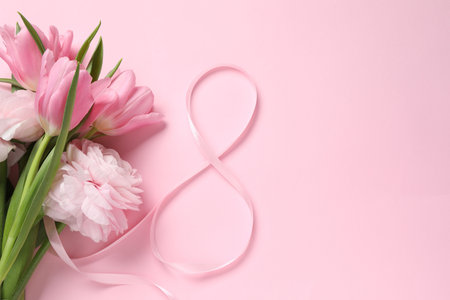 8th of March greeting card design with ribbon, beautiful flowers and space for text on pink background, flat lay. International Women's dayの写真素材