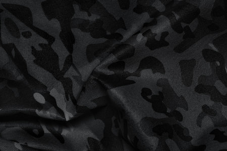 Texture of crumpled camouflage fabric as background, top view. Black and white effect