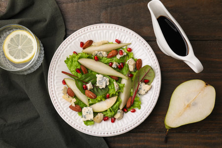Delicious pear salad with sauce on wooden table, flat layの写真素材