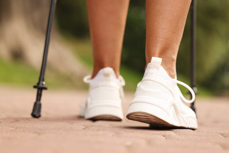 Woman performing Nordic walking outdoors, closeup viewの写真素材