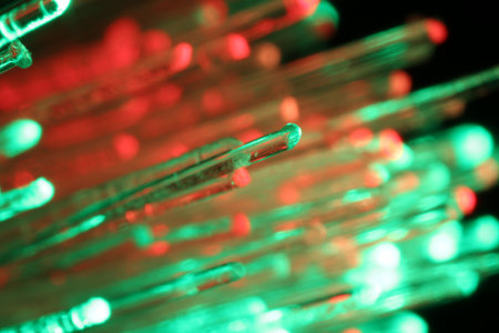 Optical fiber strands transmitting different color lights in darkness, macro viewの写真素材