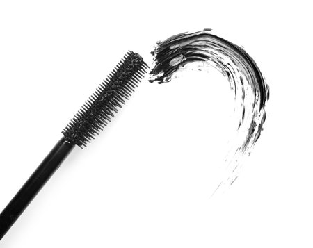 Smear of black mascara and applicator isolated on white, top viewの写真素材