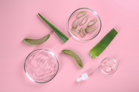 Flat lay composition with aloe vera leaves and cosmetic gel on pink backgroundの写真素材