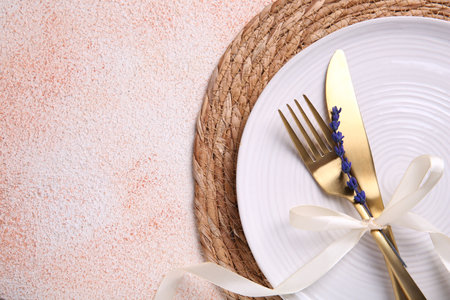 Cutlery, plate and preserved lavender flower on color textured table, top view. Space for textの写真素材