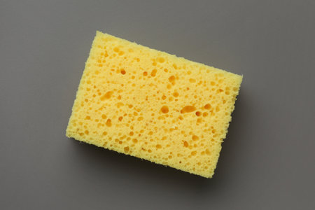 New yellow sponge on gray background, top viewの写真素材