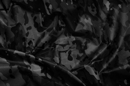 Texture of crumpled camouflage fabric as background, top view. Black and white effectの写真素材