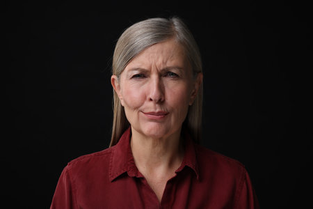 Personality concept. Portrait of emotional woman on black backgroundの写真素材