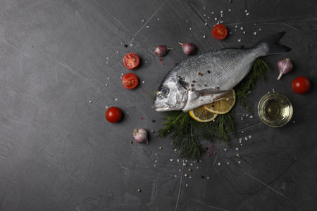 Fresh dorado fish and ingredients on gray table, flat lay. Space for textの写真素材