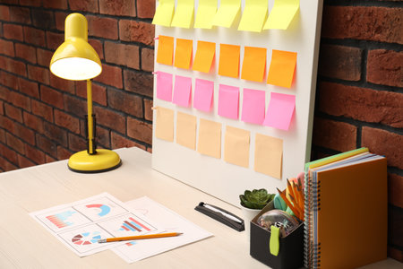 Business process planning and optimization. Workplace with colorful paper notes and other stationery on tableの写真素材
