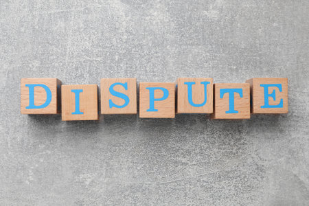 Cubes with word Dispute on gray table, top viewの写真素材