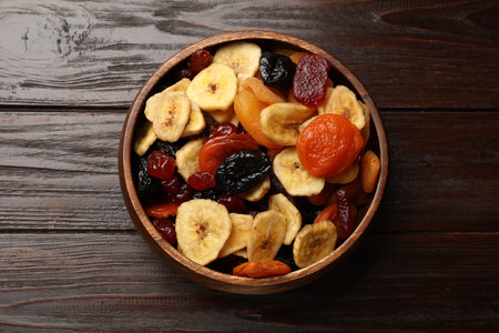 Mix of delicious dried fruits on wooden table, top viewの写真素材