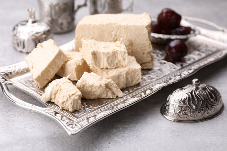 Pieces of tasty halva served on light gray table, closeupの写真素材