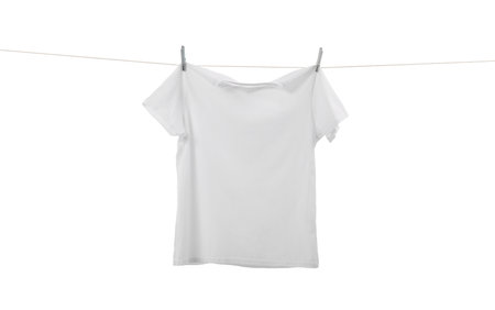 One t-shirt drying on washing line isolated on whiteの写真素材