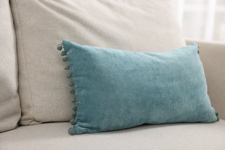 Soft pillows on beige sofa in roomの写真素材