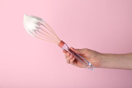 Woman holding whiskey with whipped cream on pink background, closeupの写真素材