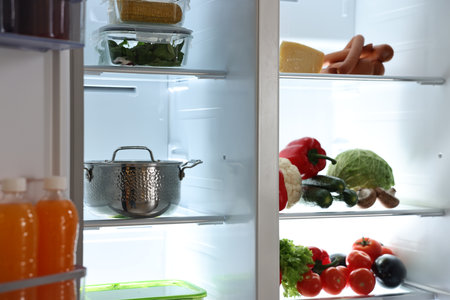 Open refrigerator full of different products indoorsの写真素材