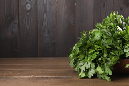 Bunch of fresh parsley on wooden table, space for textの写真素材