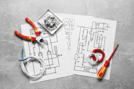 Wiring diagrams, wires and tools on gray table, flat layの写真素材
