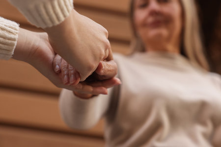 Trust and support. Women joining hands outdoors, low angle viewの写真素材