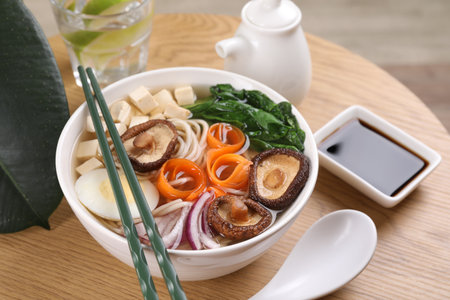 Delicious vegetarian ramen served on wooden table. Noodle soup