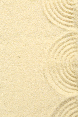 Zen rock garden. Wave pattern on beige sand, top viewの写真素材